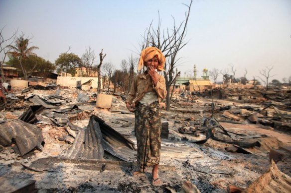 A Buddhist woman cries for her home that was burned down during the riot in Meikhtila